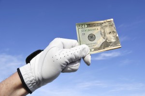 Golfer Wearing Golf Glove Holding a Twenty Dollar Bill