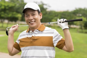 Portrait of a mature golf player smiling and looking at camera